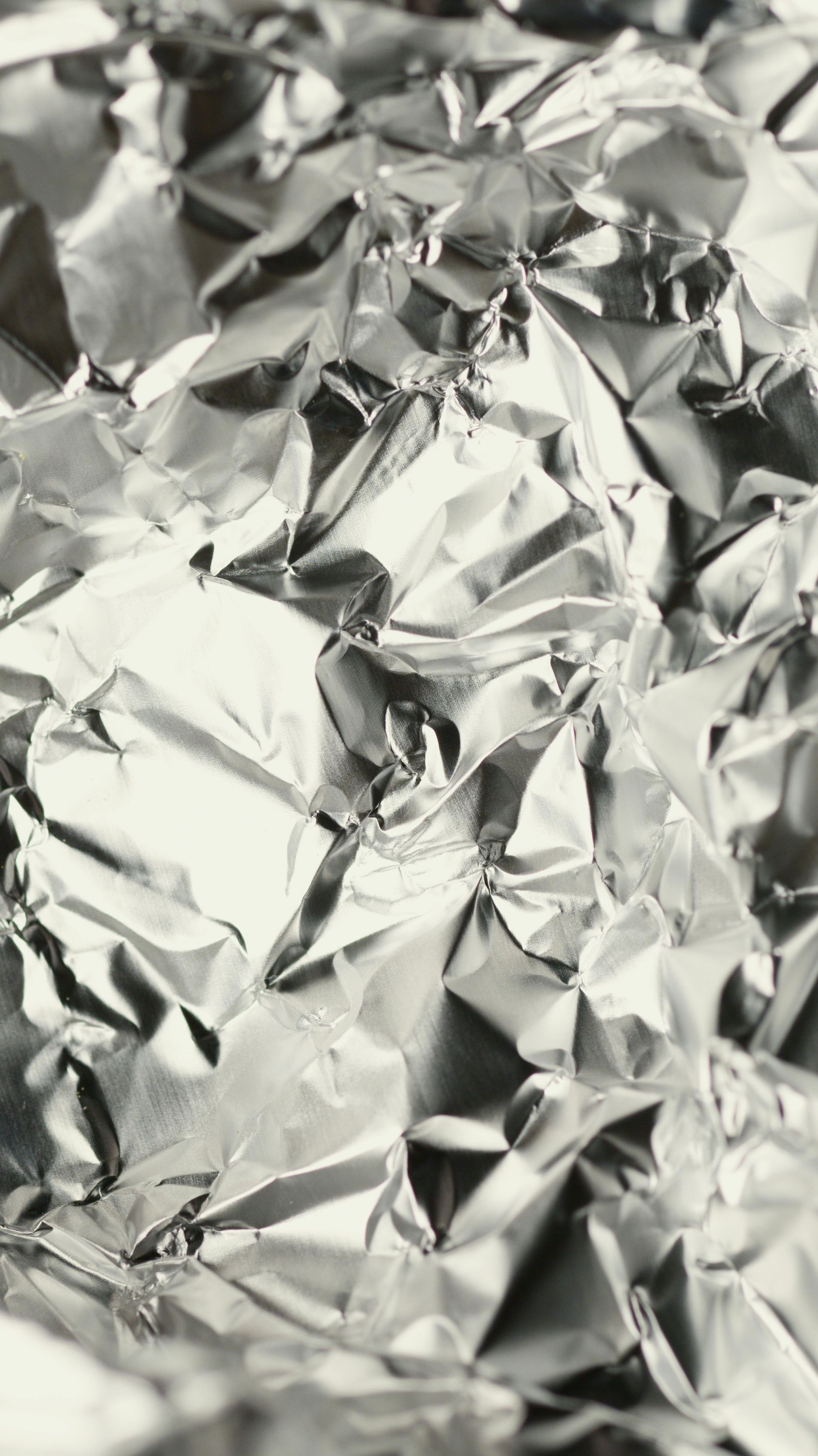 Email Us About Sponsoring This Event Crinkled silver aluminum foil filling the frame
