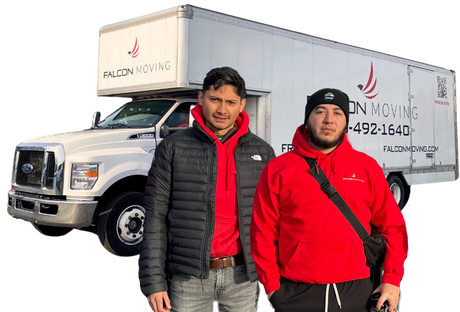 Two people in red hoodies stand in front of a white moving truck branded