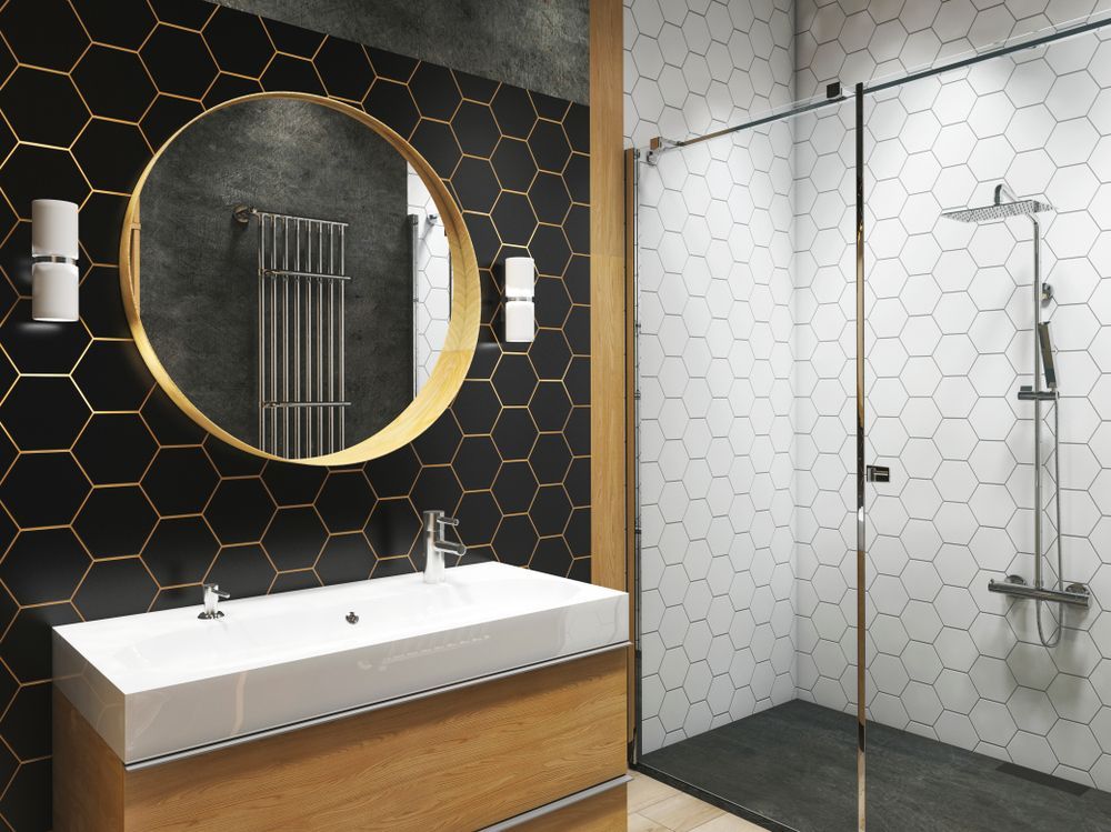 A bathroom with a sink , mirror and shower.