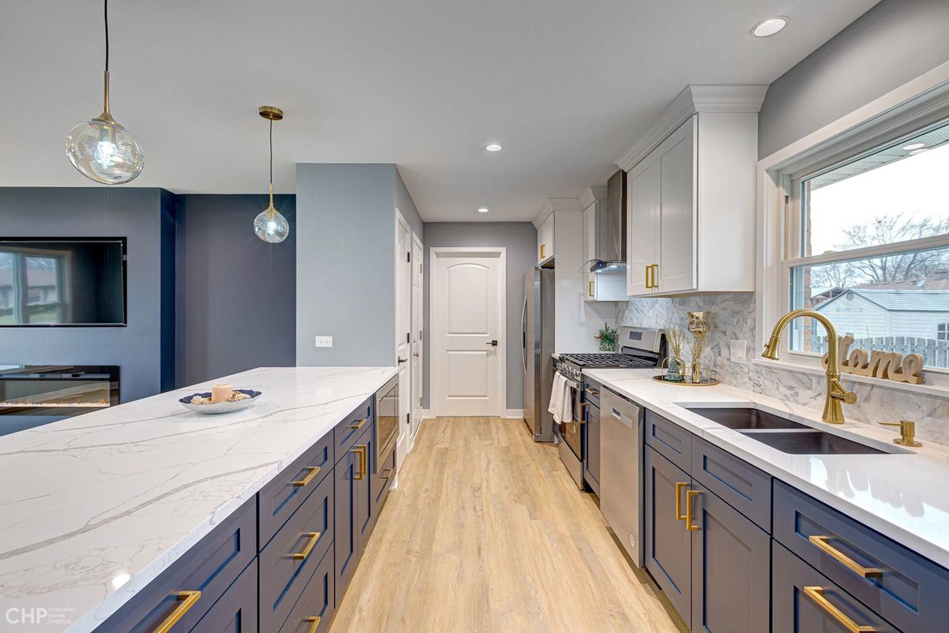 A kitchen with blue cabinets and white counter tops
