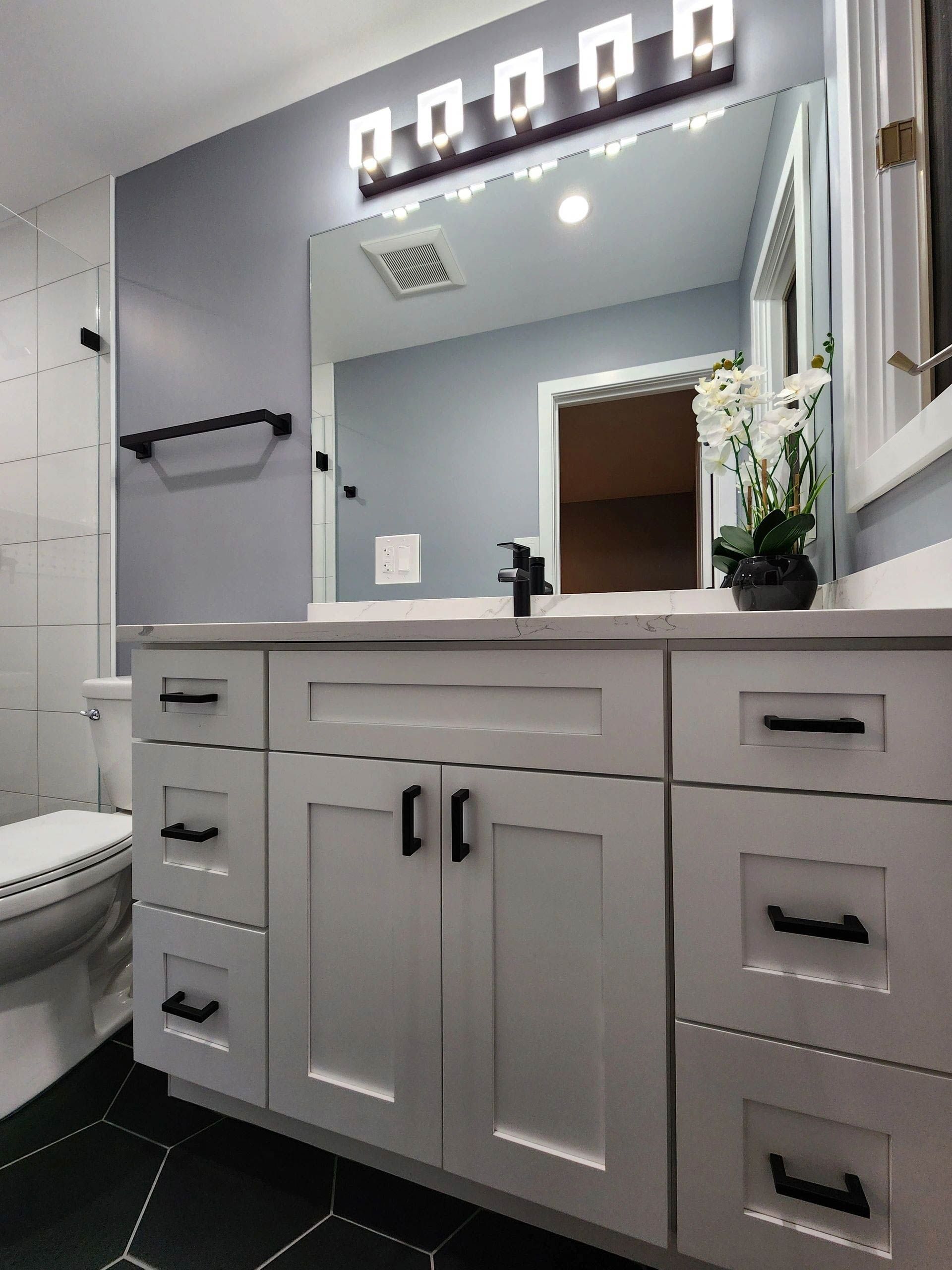 A bathroom with a sink, toilet and mirror