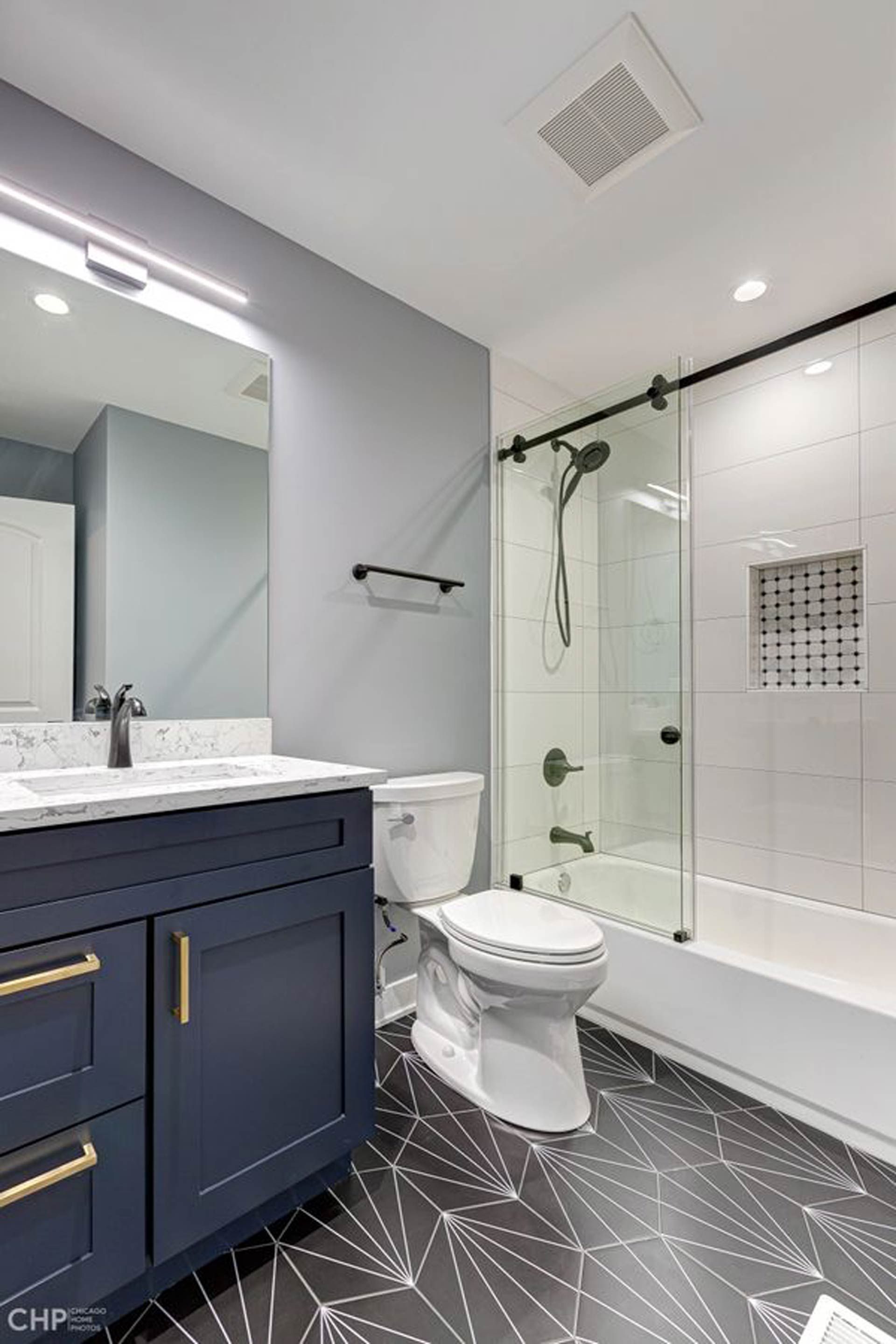 A bathroom with a toilet, sink, and shower