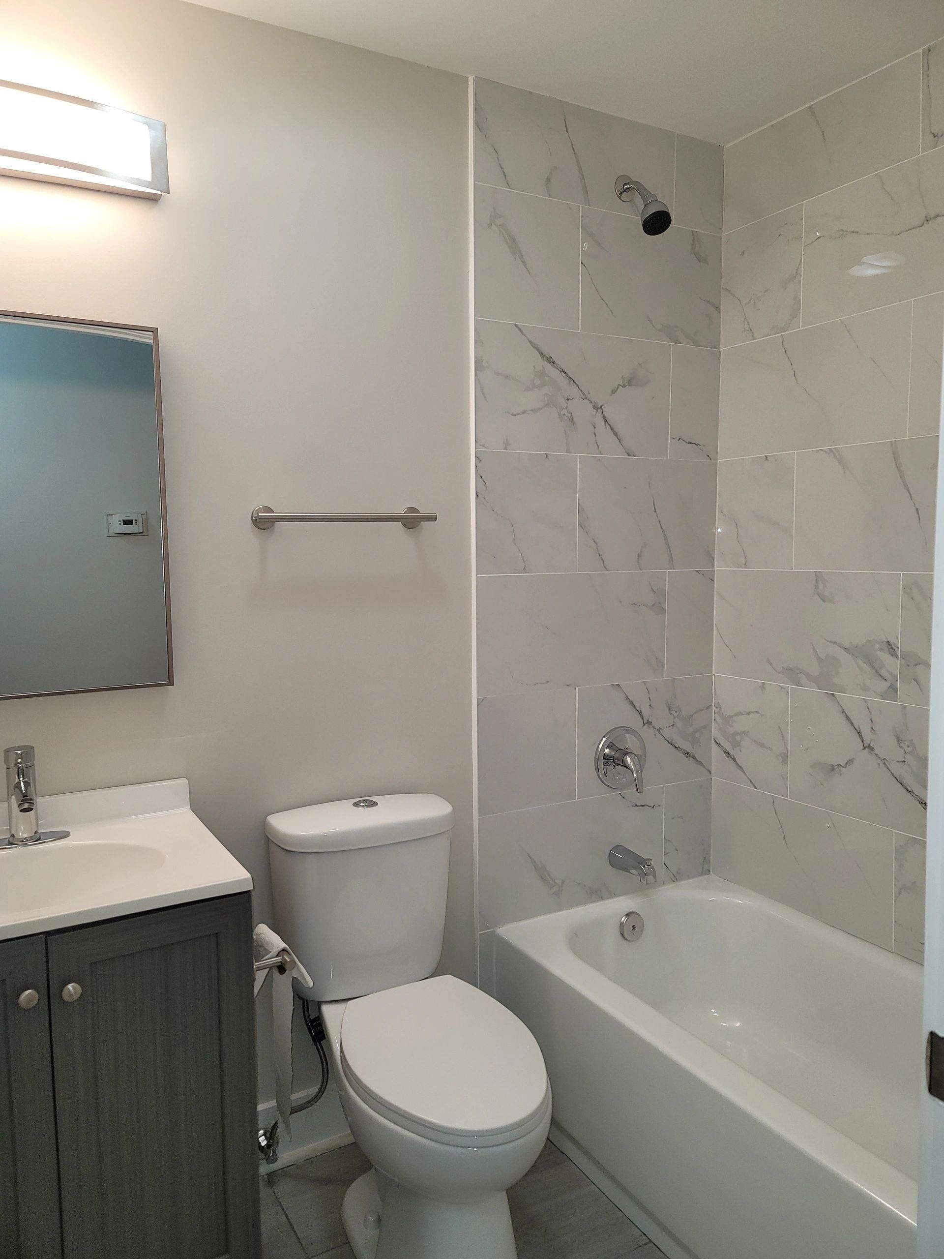 A bathroom with a toilet, sink, and bathtub