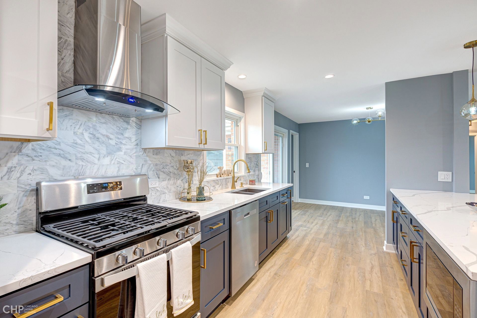 A kitchen with stainless steel appliances and white cabinets