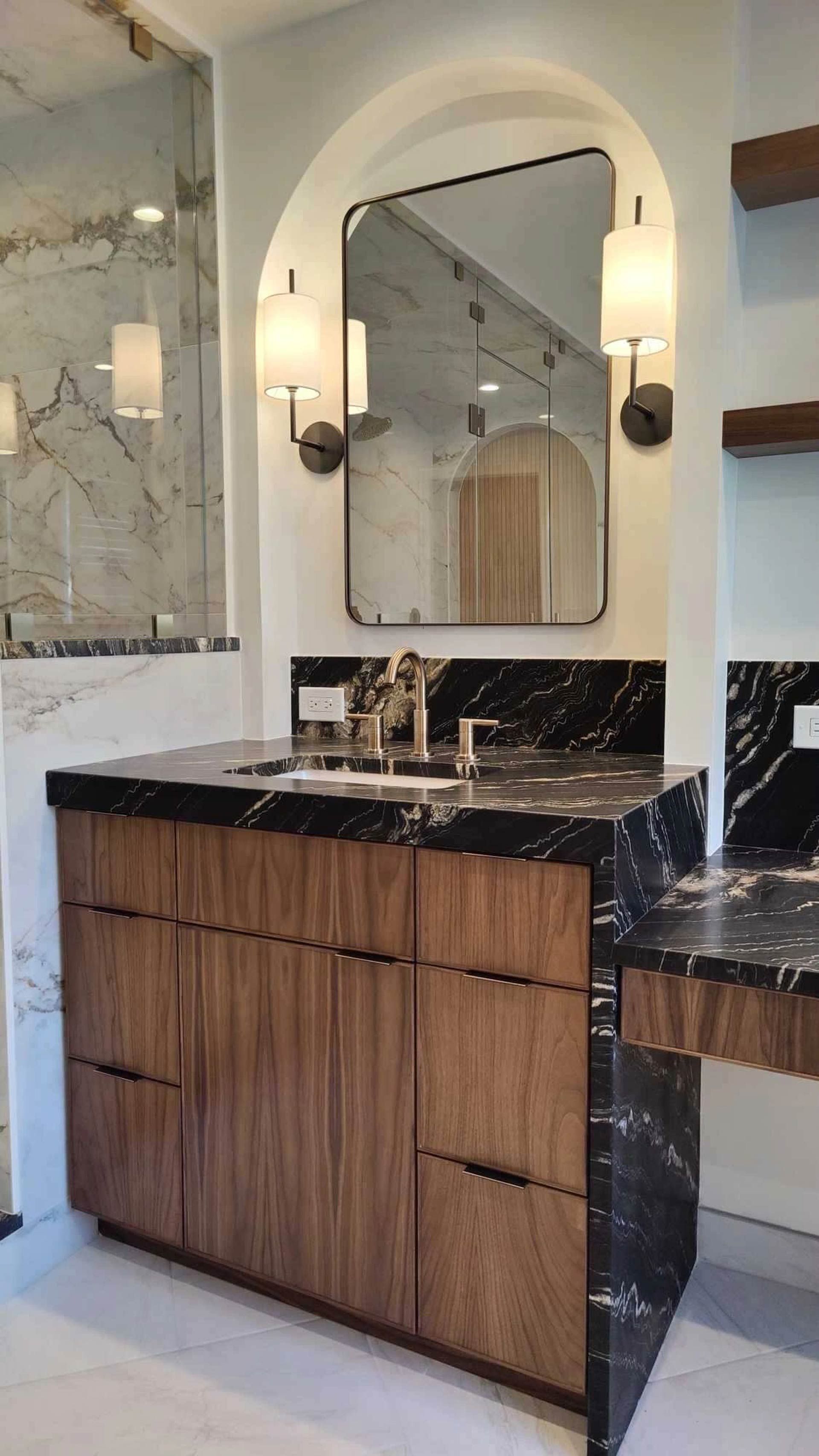 A bathroom with a sink, mirror, and wooden cabinets