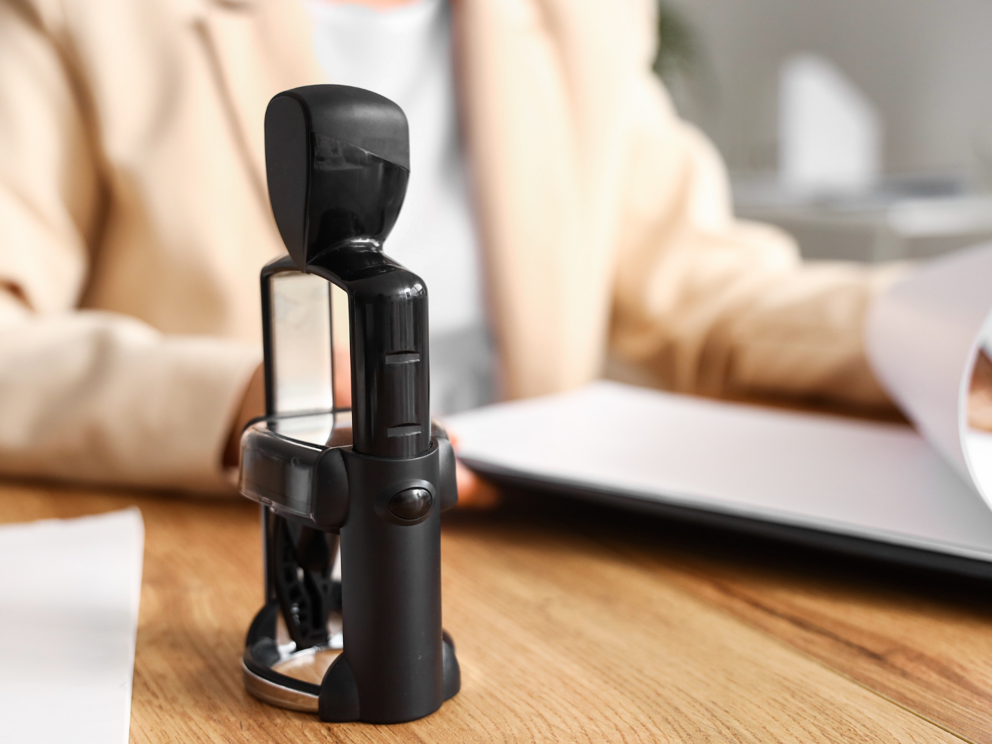 A close up of a stamp on a wooden table.