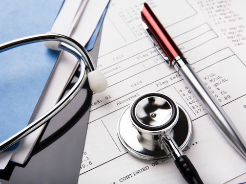 A stethoscope is sitting on top of a medical form