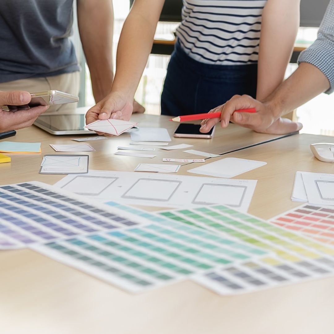 Creative team working on product packaging that enhances visibility and customer appeal.