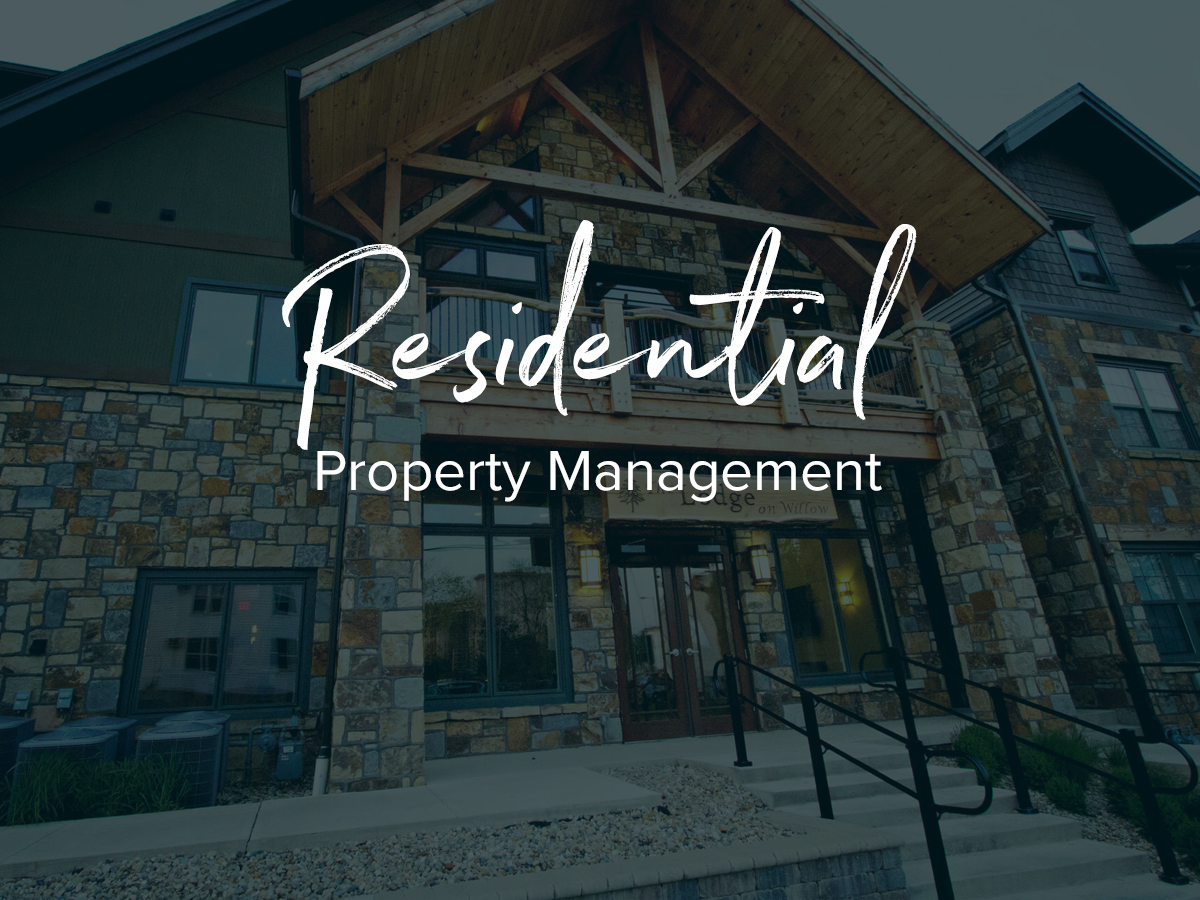 A large stone building with the words residential property management written on it