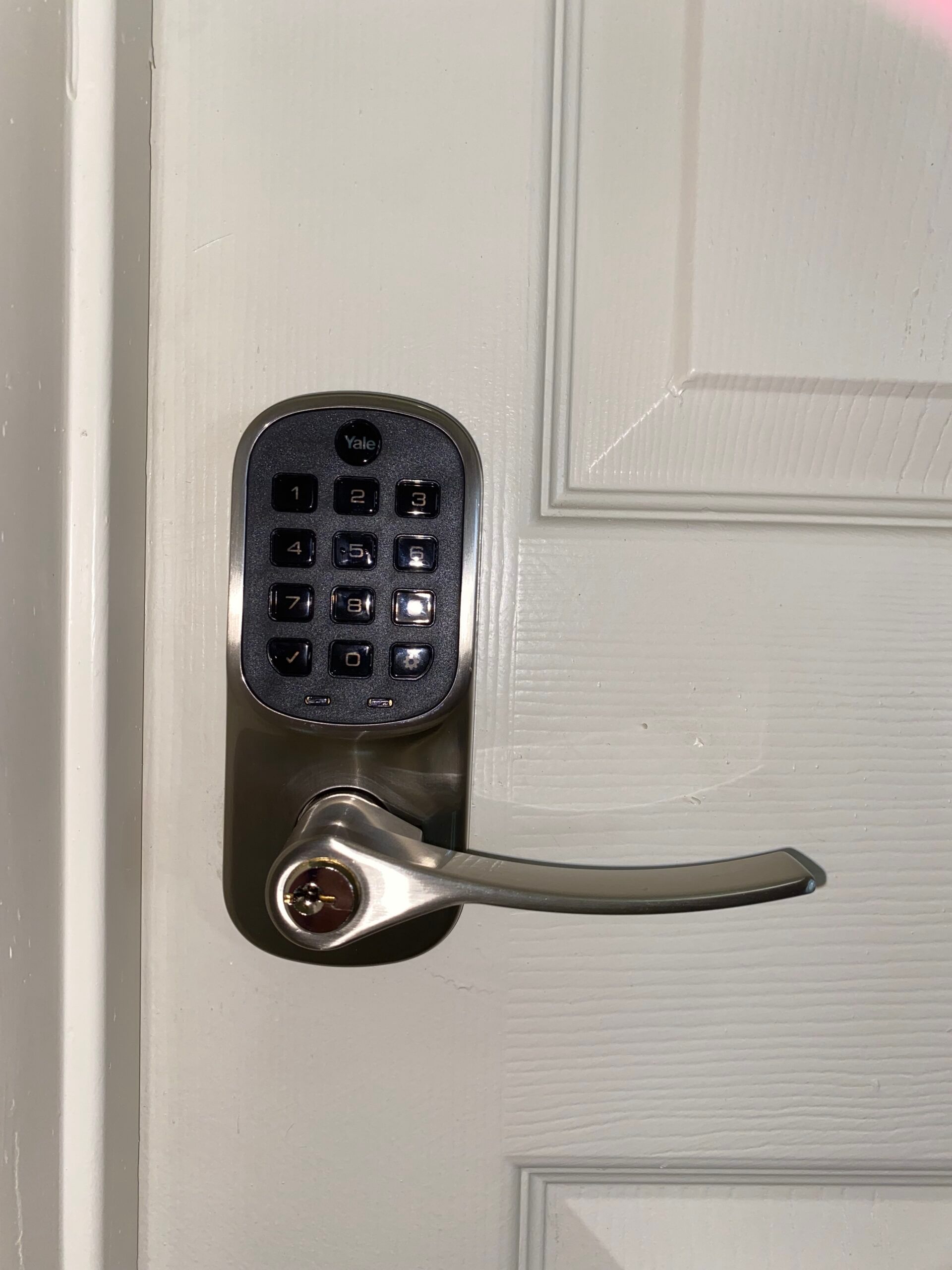 A close up of a door with a digital lock on it.