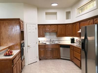 A kitchen with wooden cabinets and stainless steel appliances.