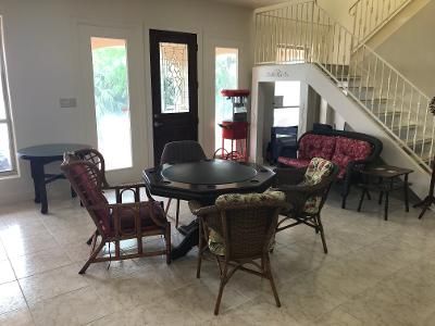 A living room with a table and chairs and a staircase