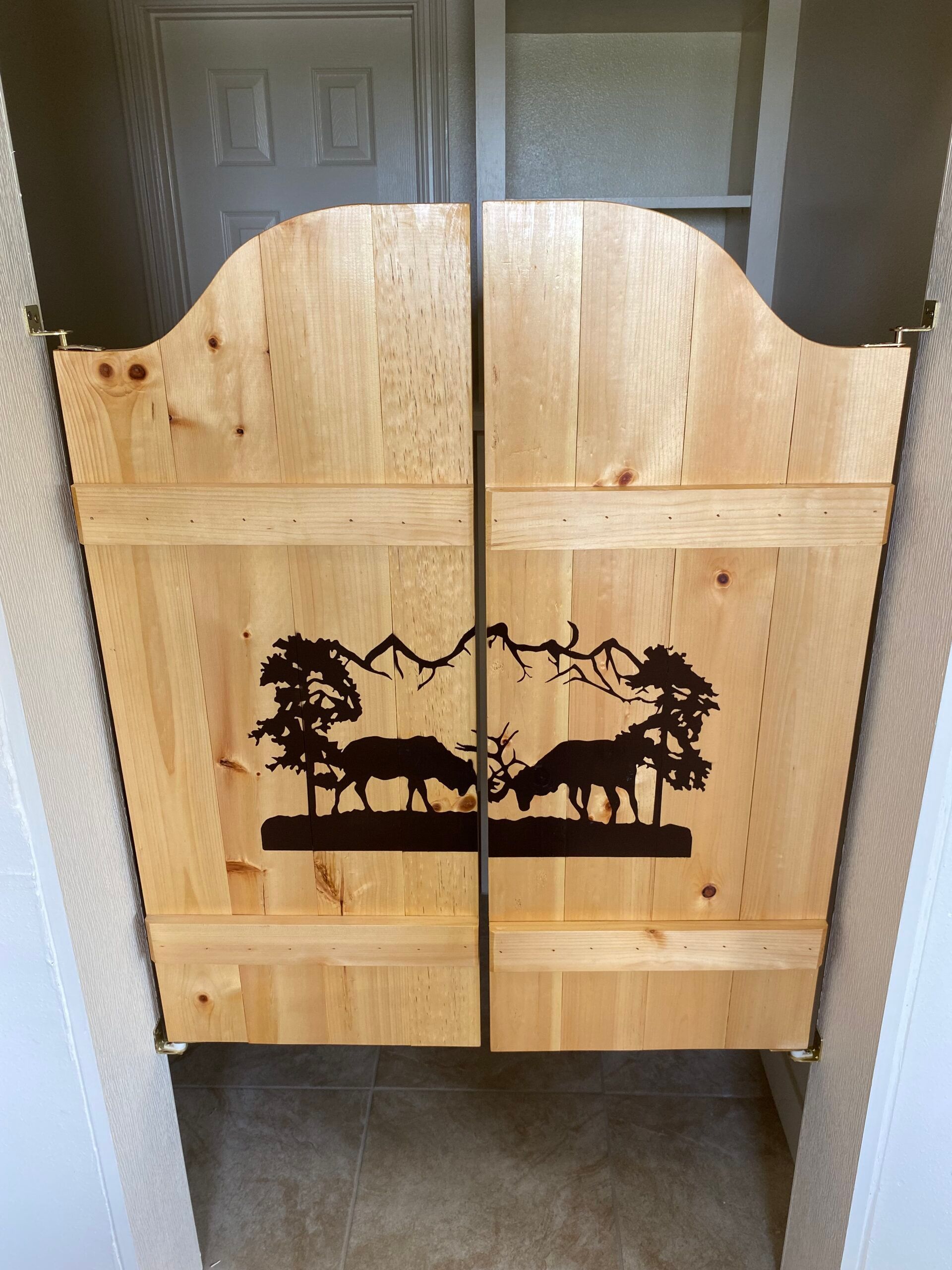 A wooden door with a picture of two cows on it