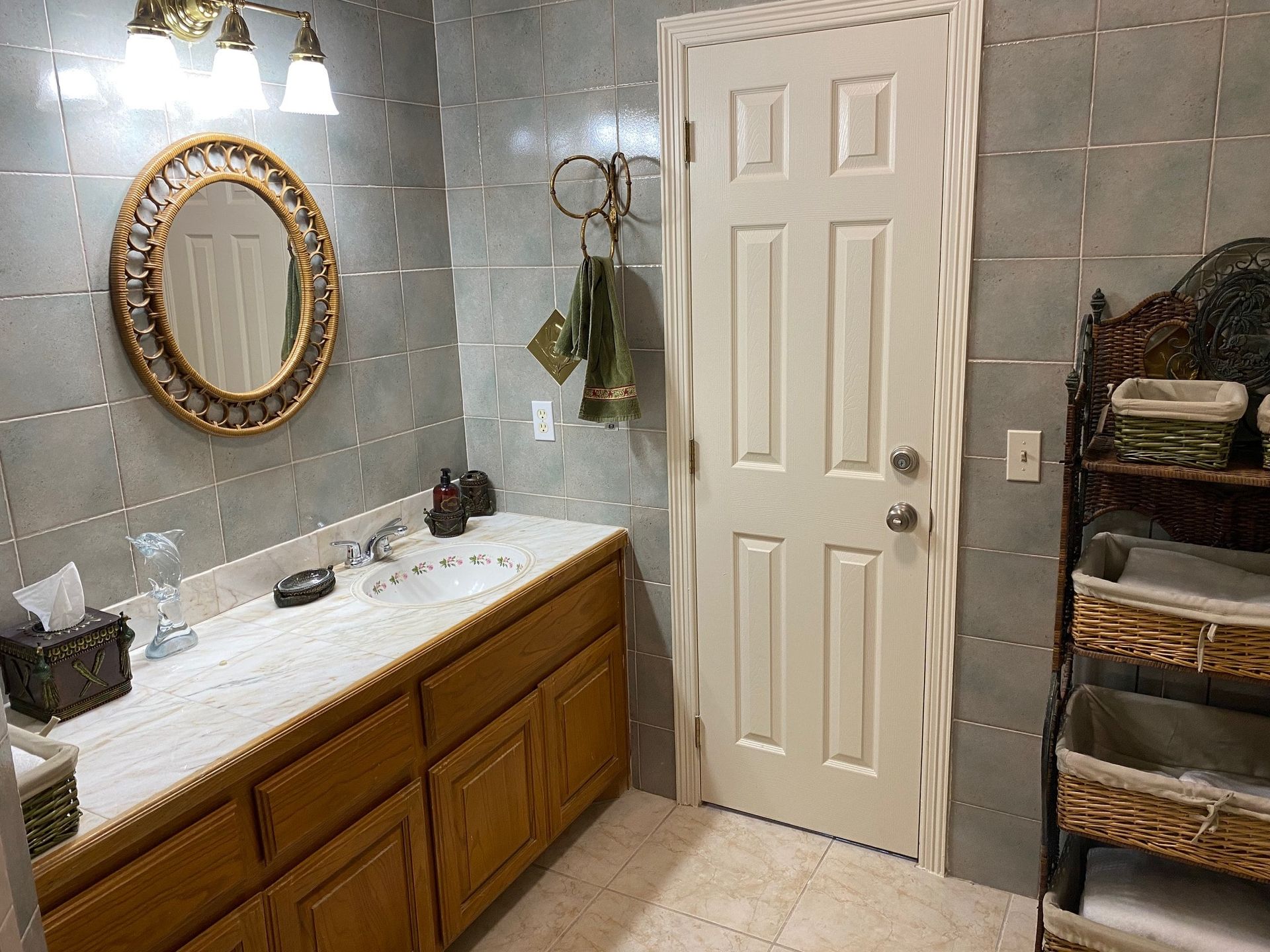 A bathroom with two sinks , a mirror and a door.