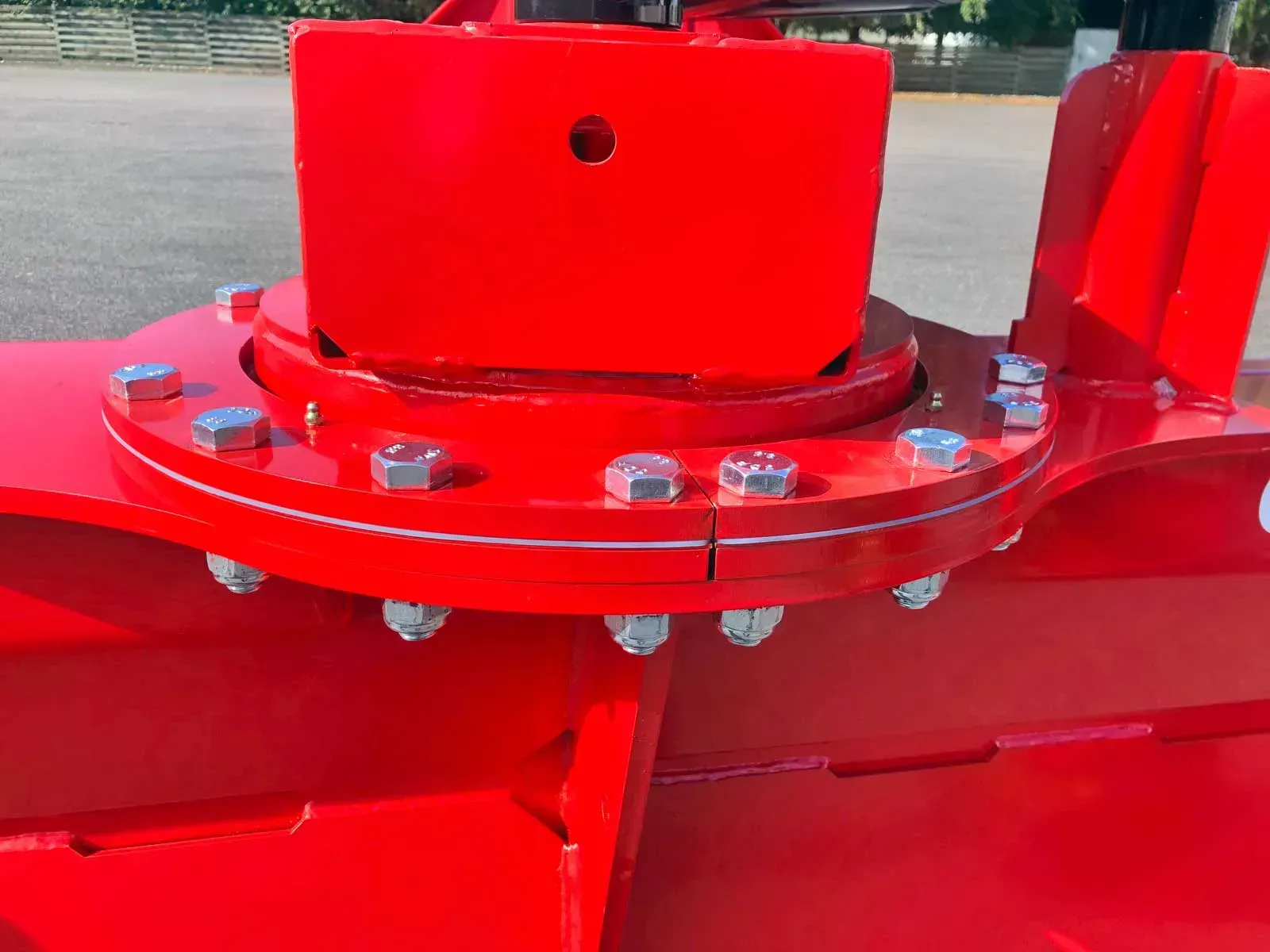 Eine Nahaufnahme eines roten Objekts mit Schrauben und Muttern darauf.