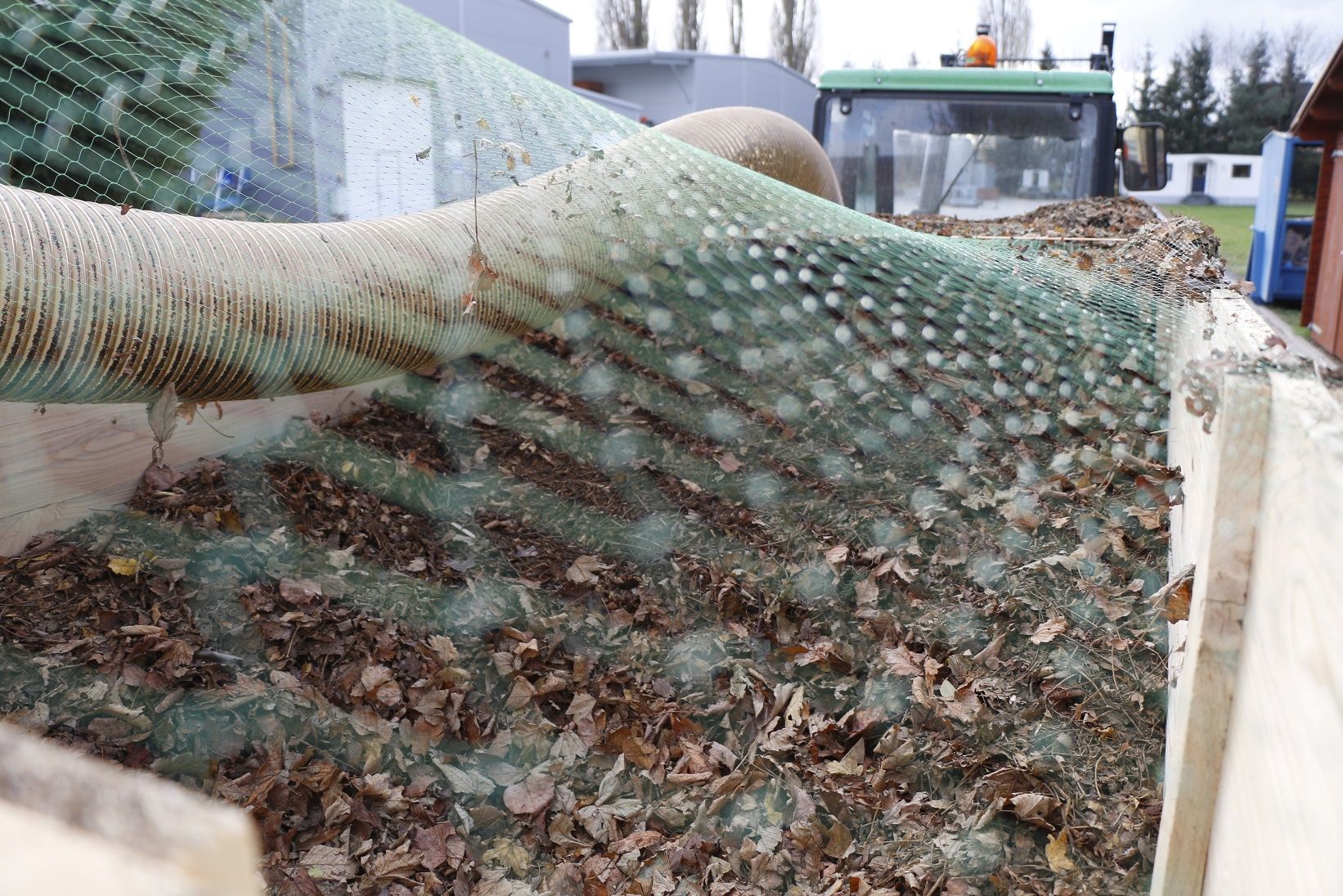 Ein grünes Netz bedeckt einen Blätterhaufen.