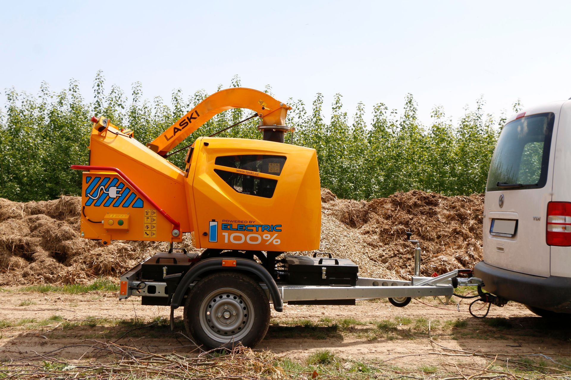 Eine gelbe Maschine wird von einem weißen Lieferwagen abgeschleppt.