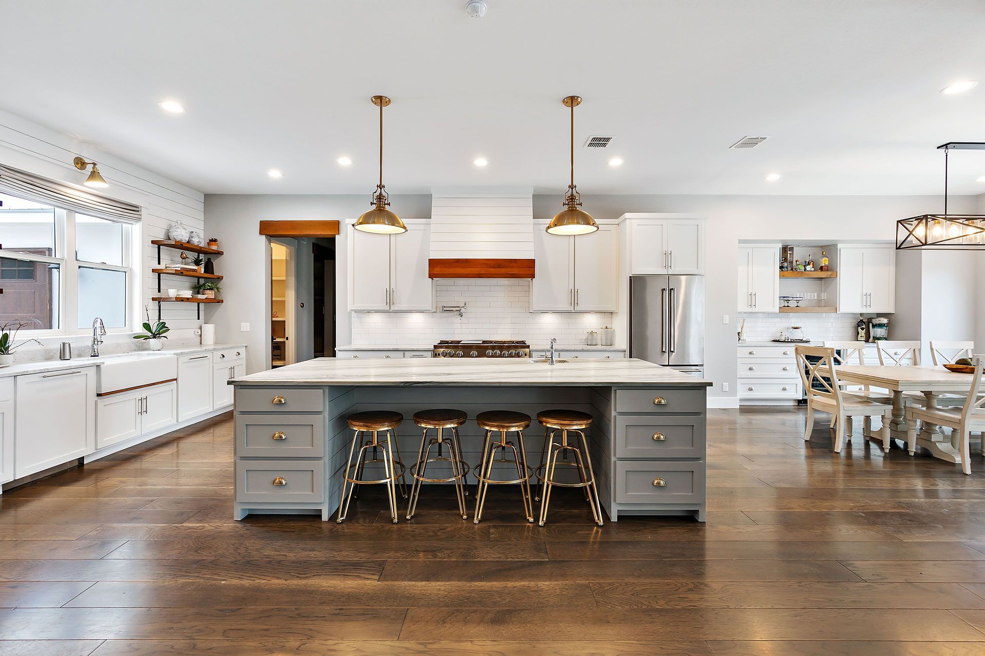 A large kitchen with white cabinets and a large island in the middle.