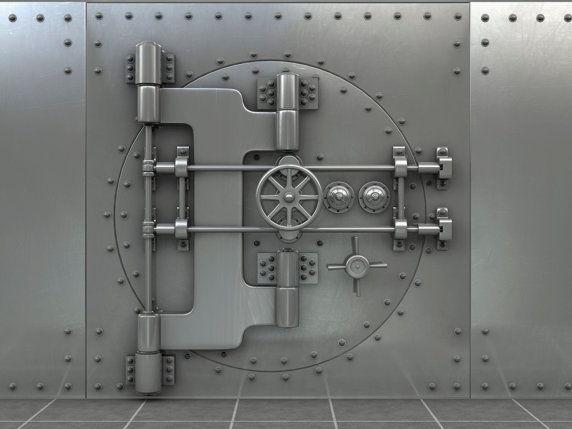 A large, silver bank vault door with a circular door and various locking mechanisms.