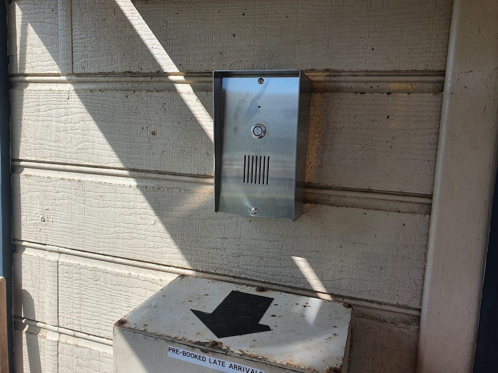 Metallic Intercom on Exterior Wall With Sign — AitkenTech in Batemans Bay, NSW