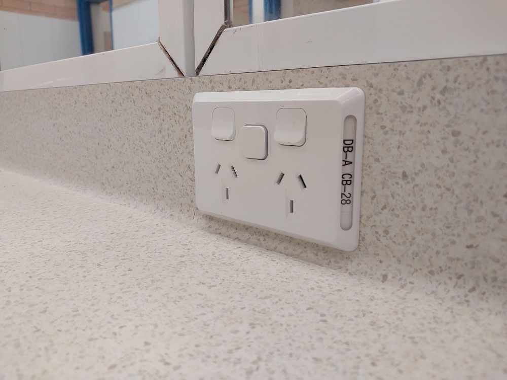 Double Power Outlet on a Speckled Countertop — AitkenTech in Batemans Bay, NSW
