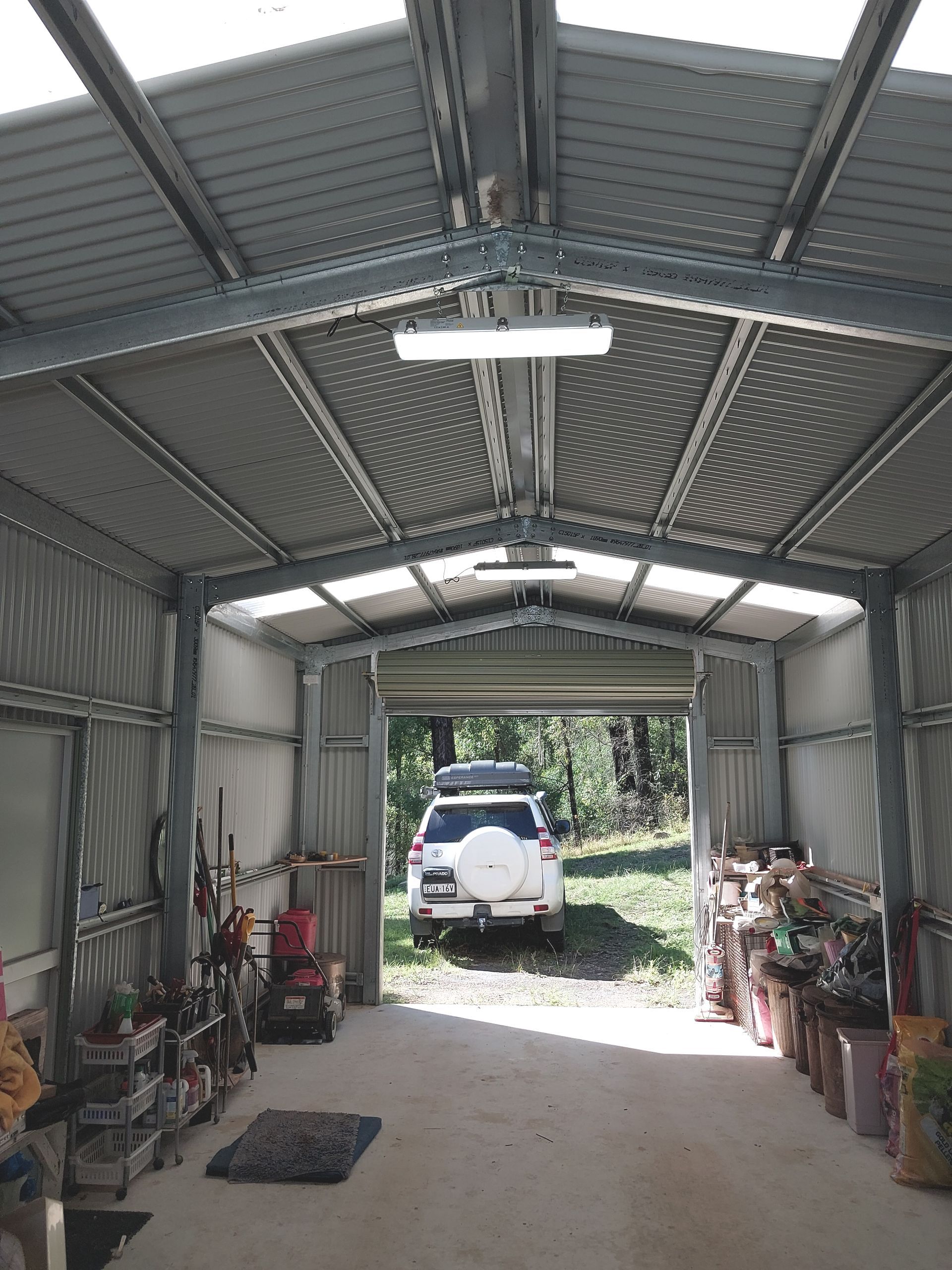 Industrial-Style Metal Shed Interior With Fluorescent Lighting — AitkenTech in Moruya, NSW