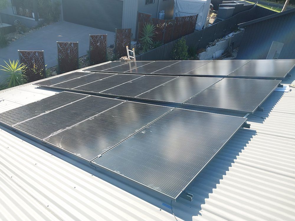 Rooftop With Multiple Solar Panels Installed — AitkenTech in Bermagui, NSW 
