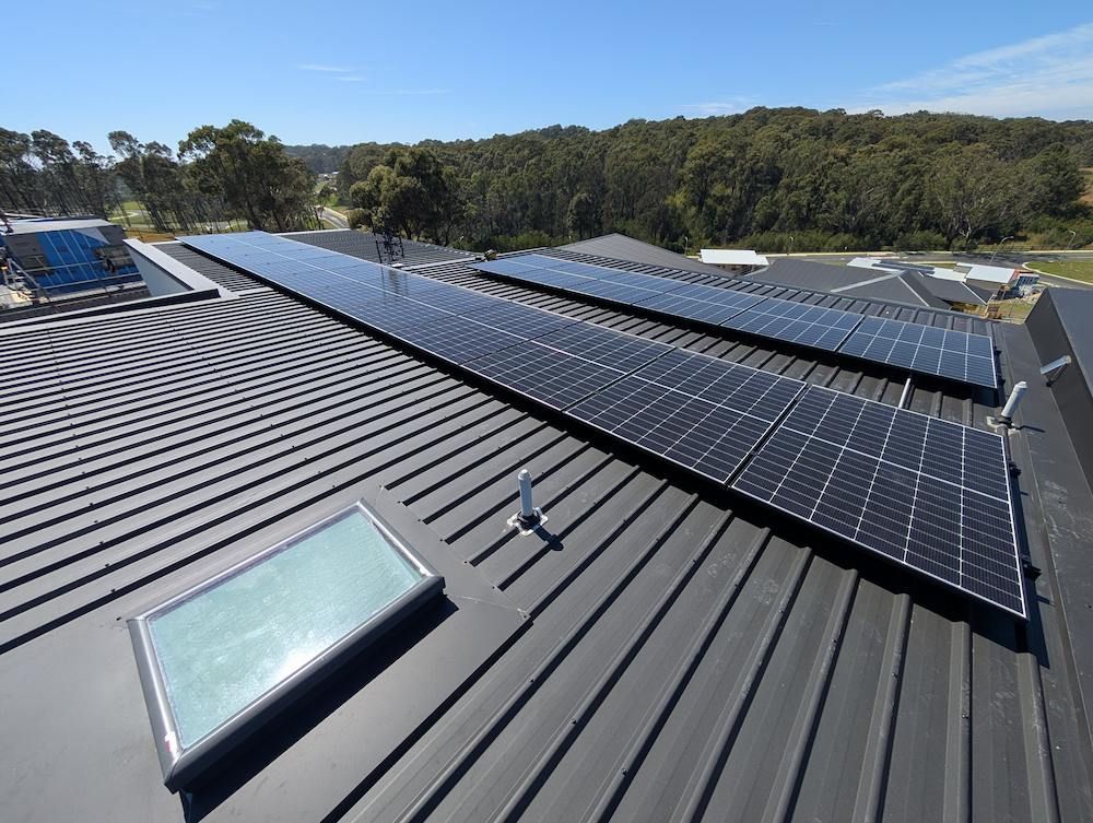 A Roof With Solar Panels and a Skylight on It — AitkenTech in Ulladulla, NSW