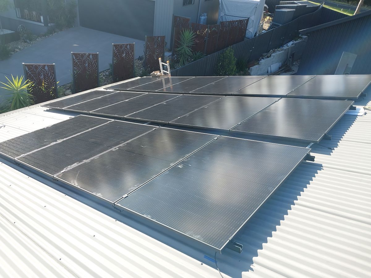 A Roof With Solar Panels and a Skylight on It — AitkenTech in Moruya, NSW