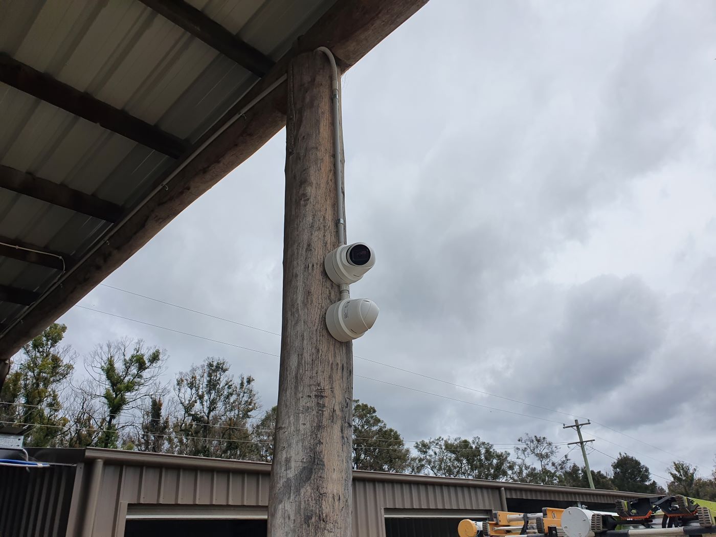 Two Cameras Are Mounted on a Wooden Pole Under a Roof — AitkenTech in Moruya, NSW