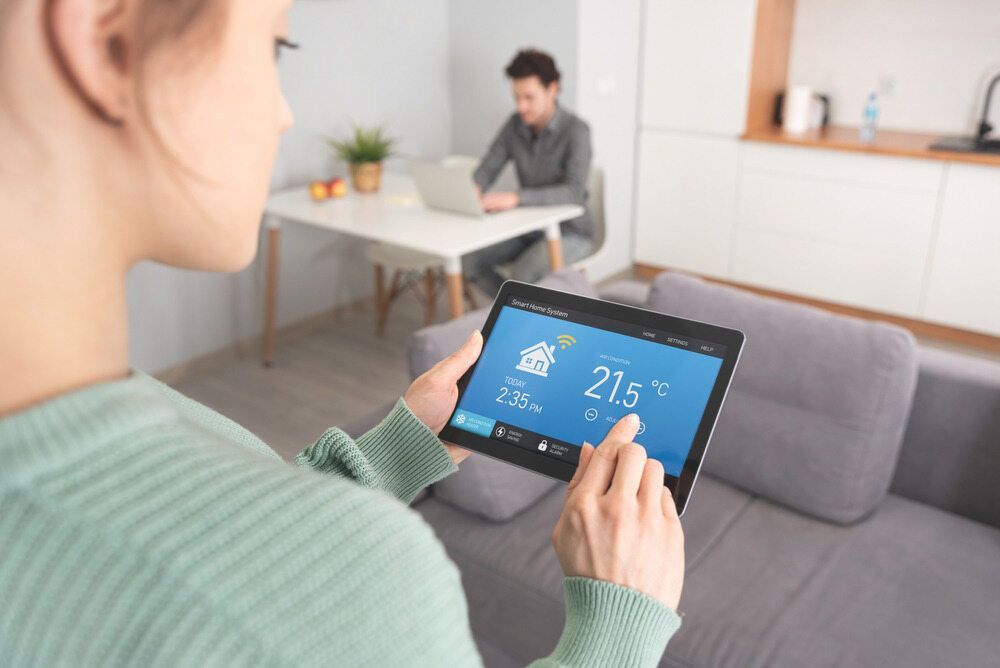 Person Holding Tablet With Home Automation Interface — AitkenTech in Batemans Bay, NSW