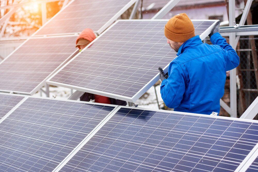 Two Men Are Installing Solar Panels on a Roof — AitkenTech in Bermagui, NSW