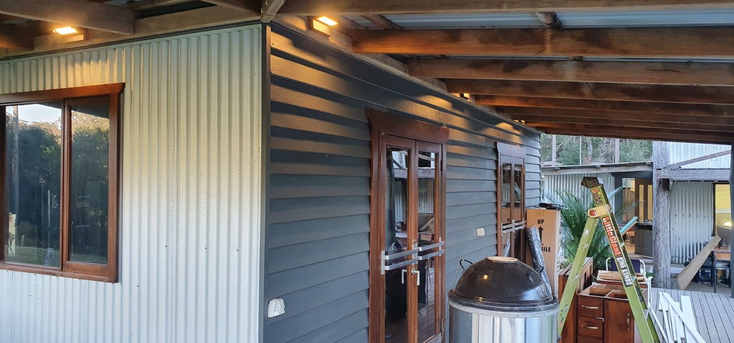 A House With A Porch and A Grill on the Side of It — AitkenTech in Batemans Bay, NSW