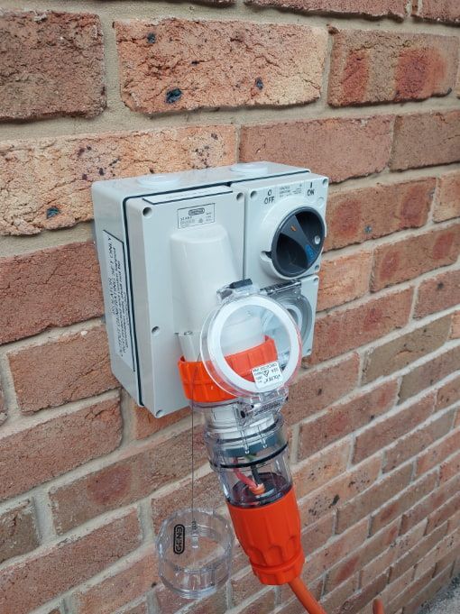 A Brick Wall With a Socket and a Cord Attached to It — AitkenTech in Ulladulla, NSW
