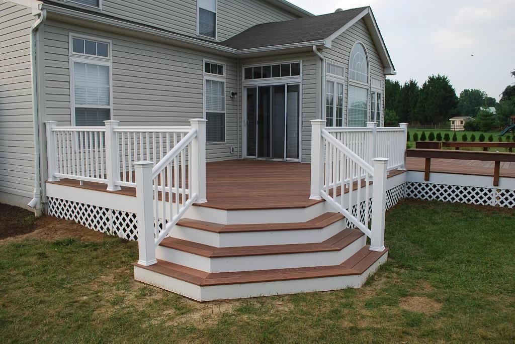 A house with a deck and stairs in front of it
