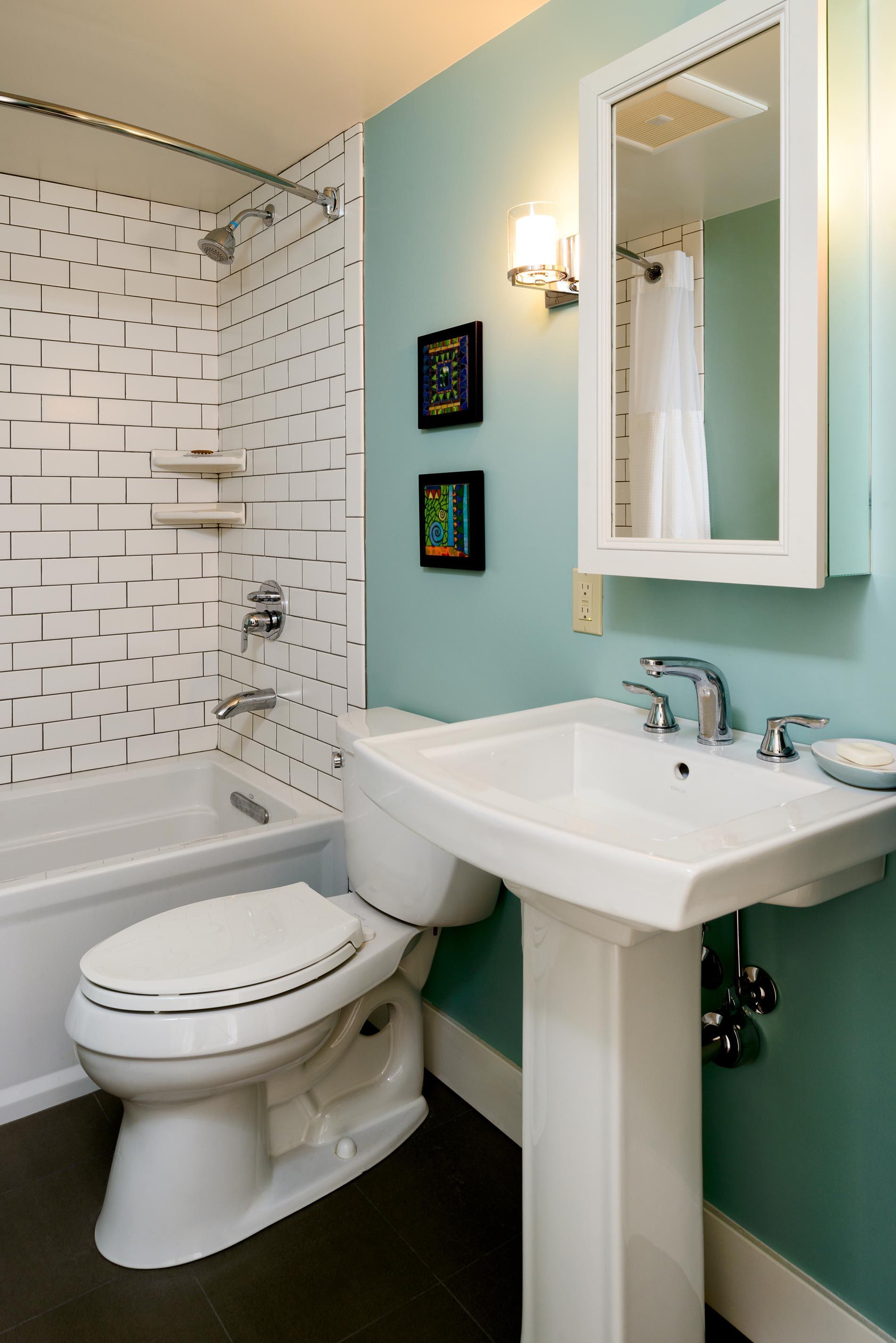A bathroom with a toilet a sink and a bathtub