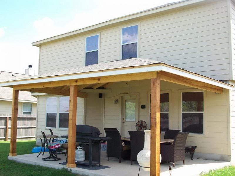 A house with a covered porch and a grill