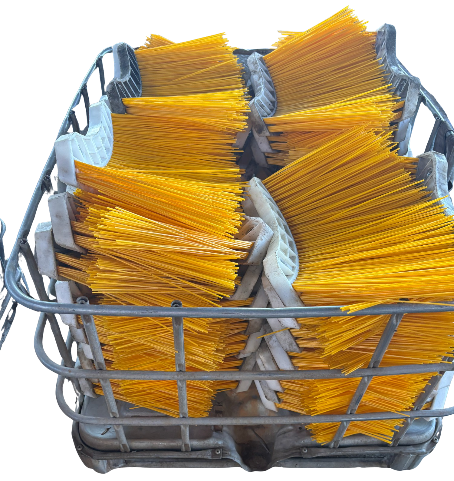 Basket of yellow-handled cleaning brushes in a gray metal wire basket