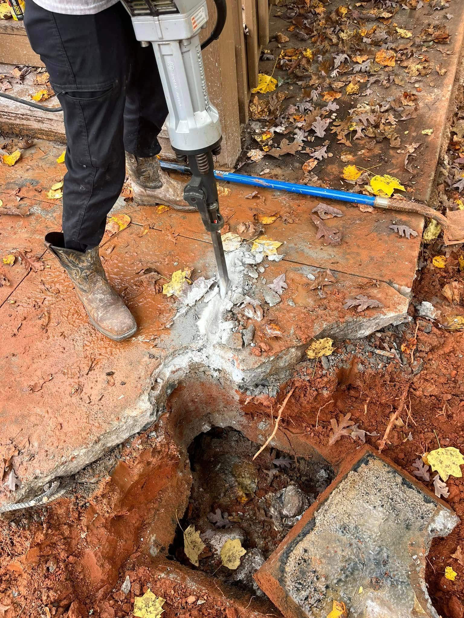 A truck is parked next to a hole in the ground.
