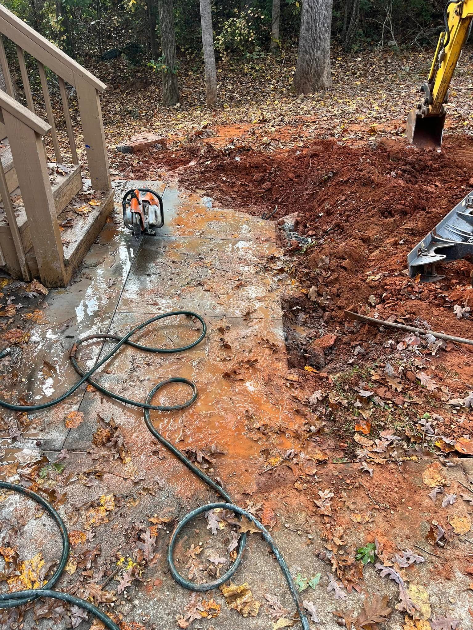 A large pile of dirt is in front of a house.