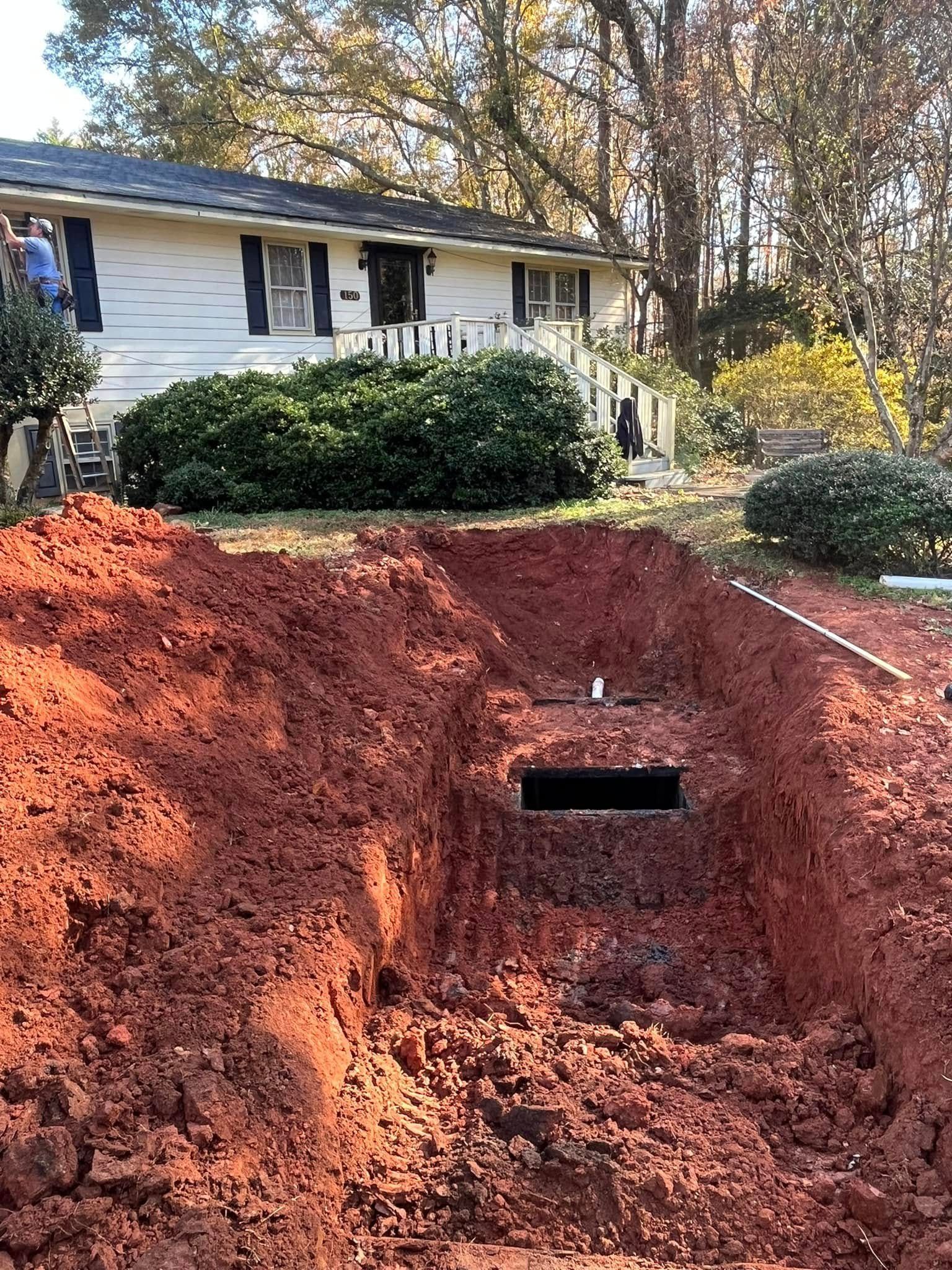 A large pile of dirt is in front of a house.