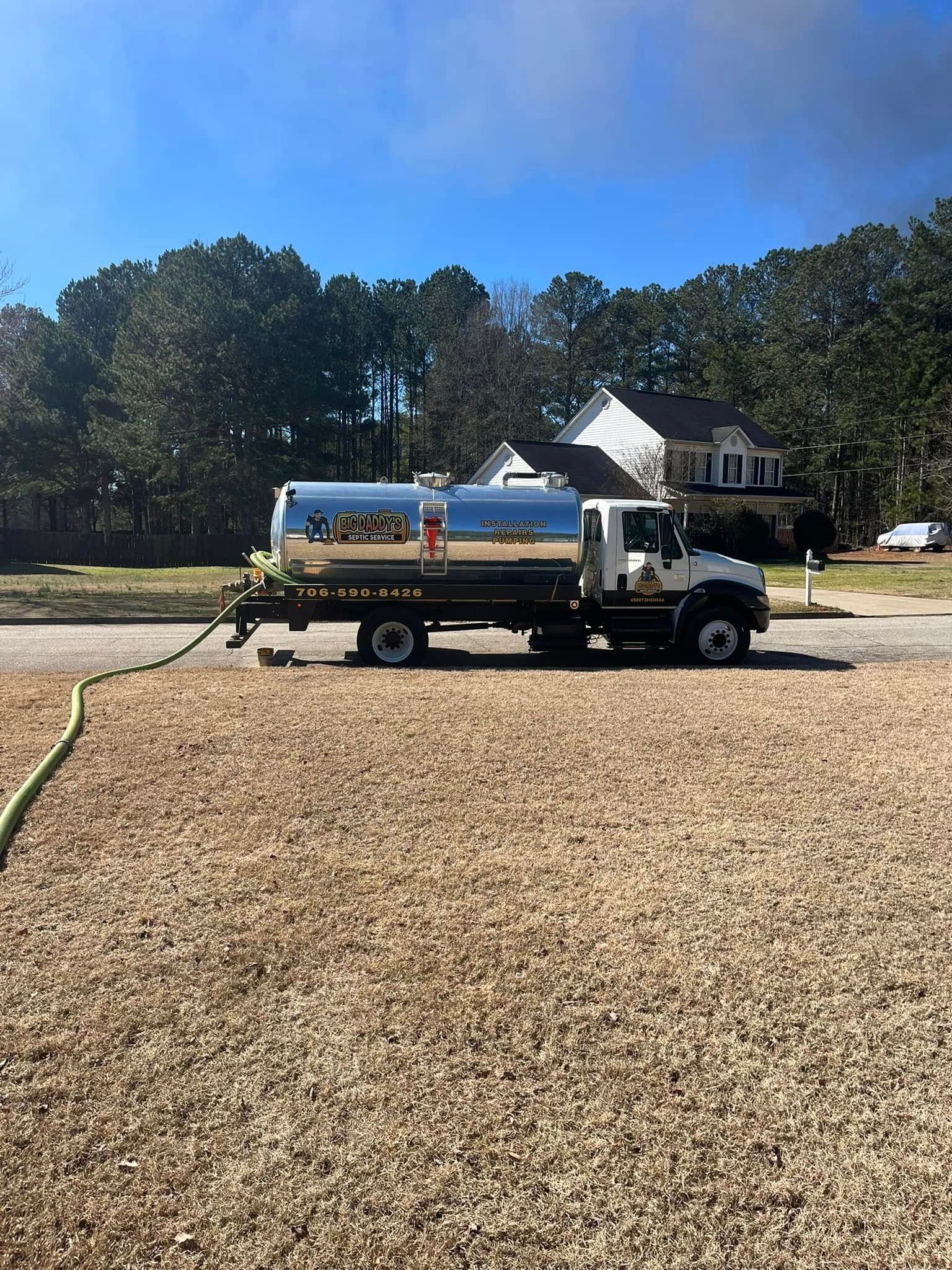A large pile of dirt is in front of a house.
