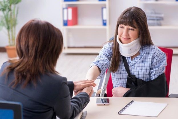 Woman With Neck Brace Shaking Hands | Maple Grove, MN | Donohue McKenney Attorneys At Law