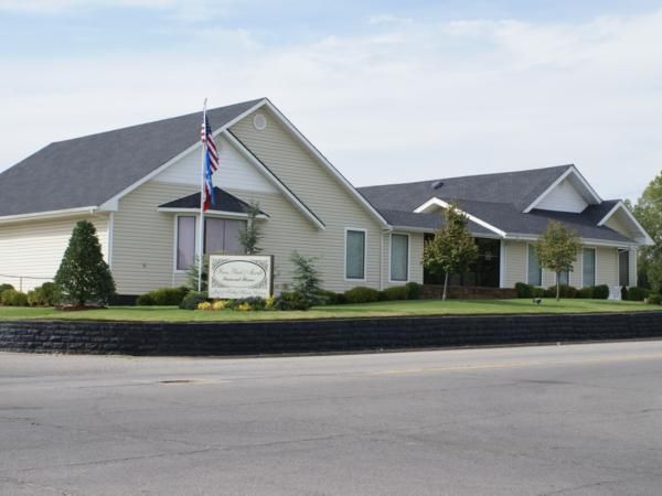 A house with a sign that says ' funeral home ' on it