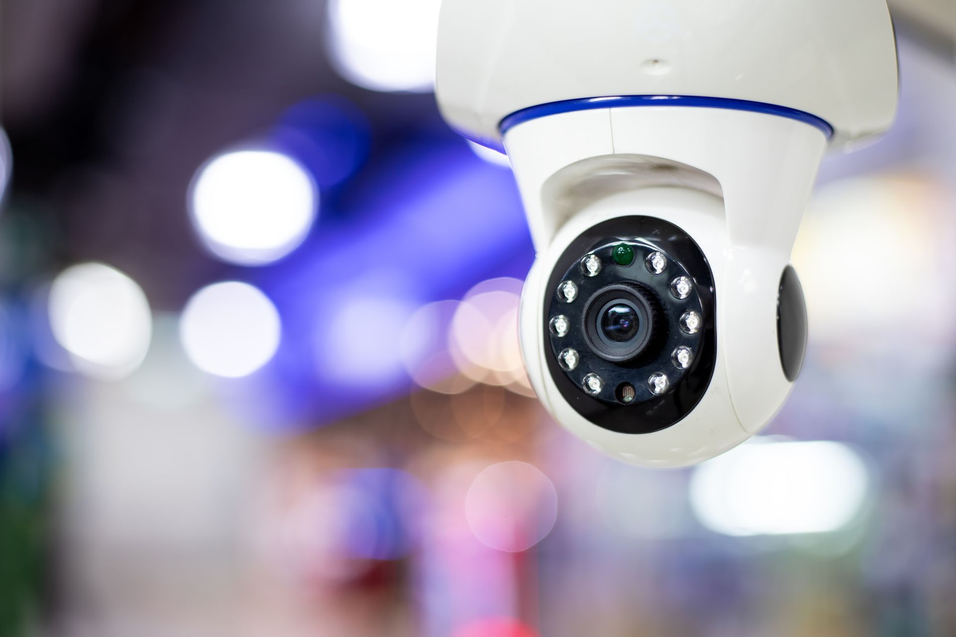 Indoor security camera with infrared LEDs monitoring retail space, modern CCTV surveillance systems.