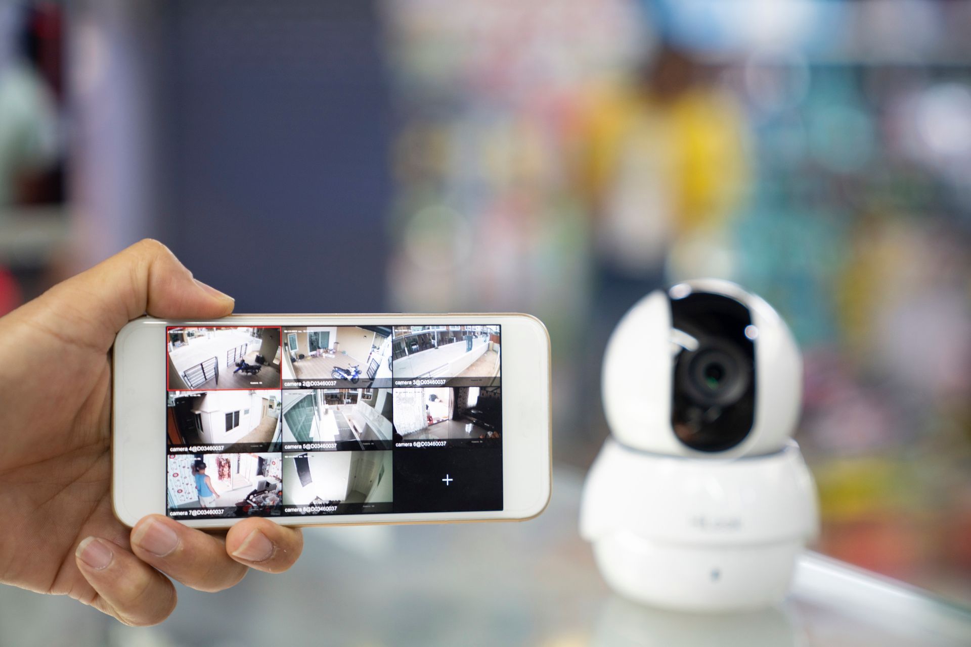 A Person's Hand Holding Mobile Phone with CCTV Camera Footage on Screen – Phoenix, AZ – Phoenix Access Control