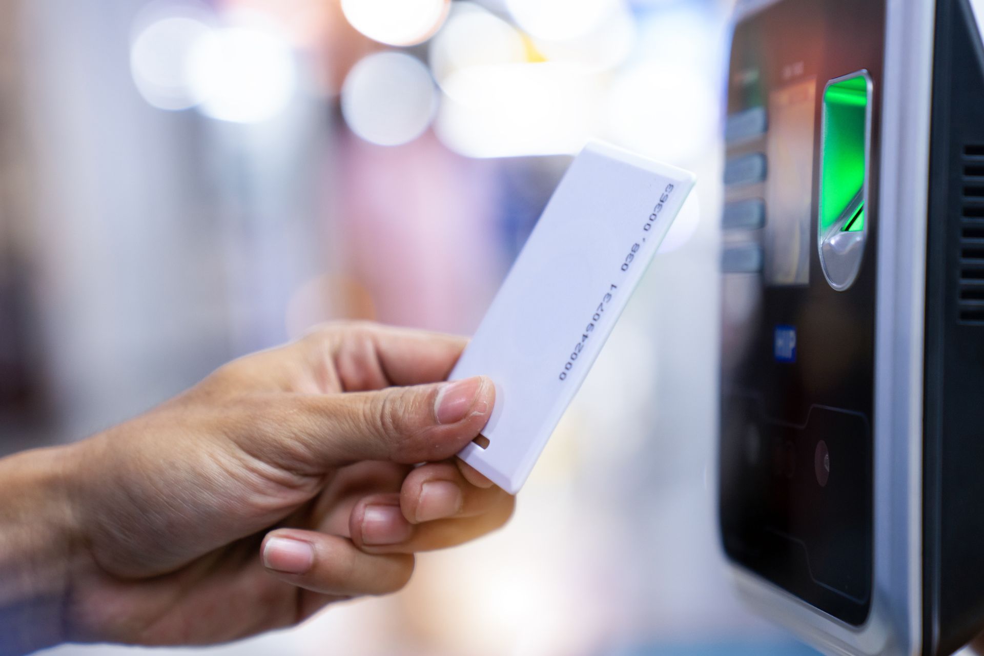 A businessman scans his security card on a commercial security system.
