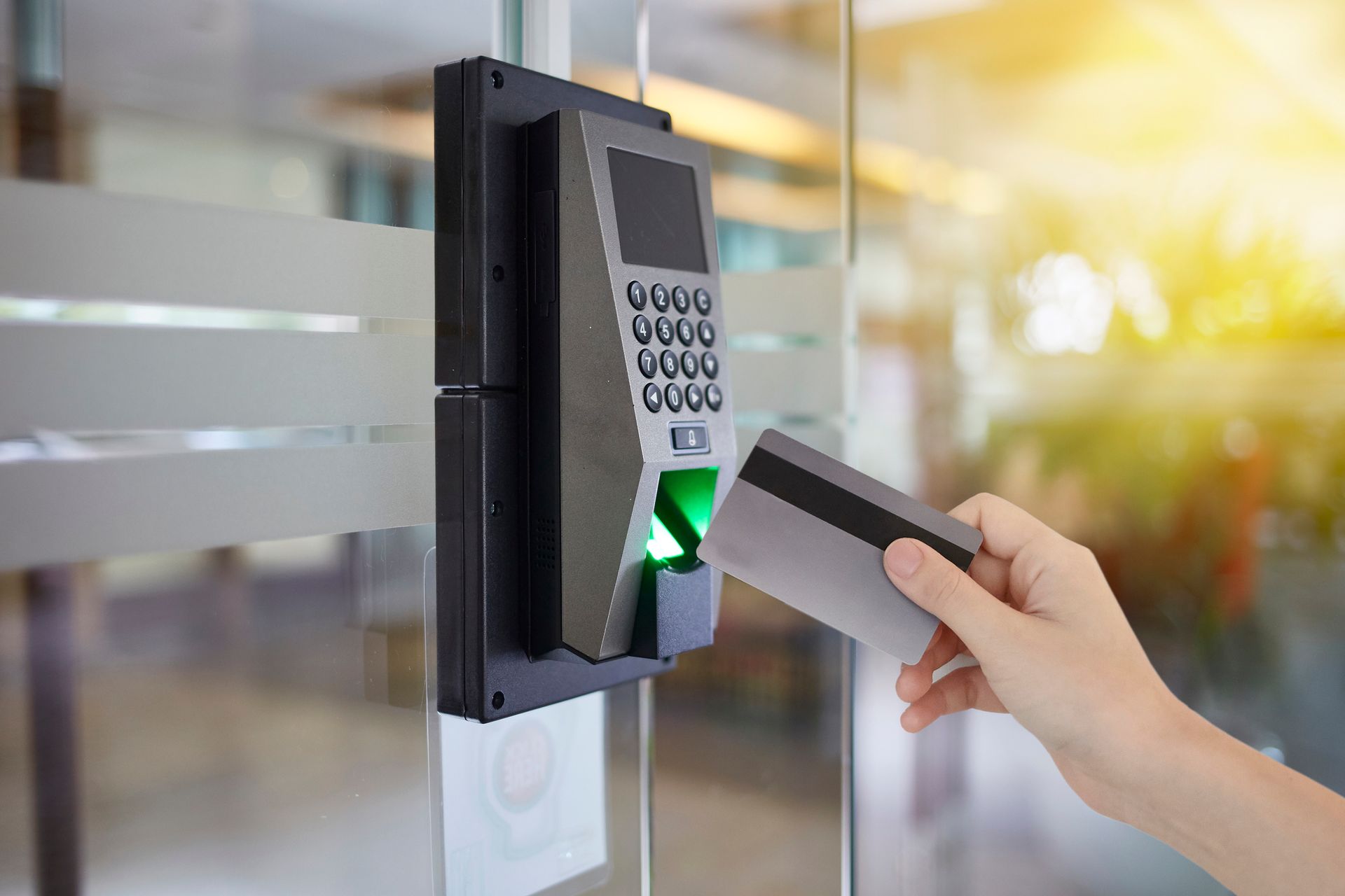 A person holds a key card to access the door office, showcasing a commercial security system.