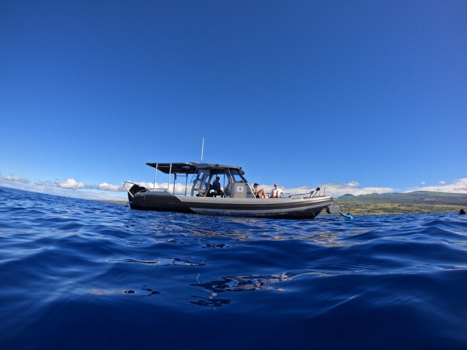 a boat in the ocean has a sticker on the side that says ' scuba diving '