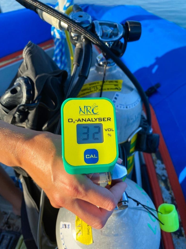 a person holding a nrc o2 analyzer in their hand